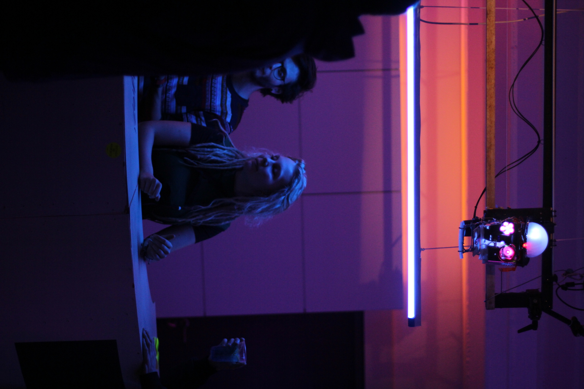 The robotic head hanging above a dimly lit bar the barserver.